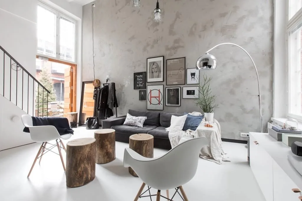An interior pairing a concrete wall with warm wooden furniture